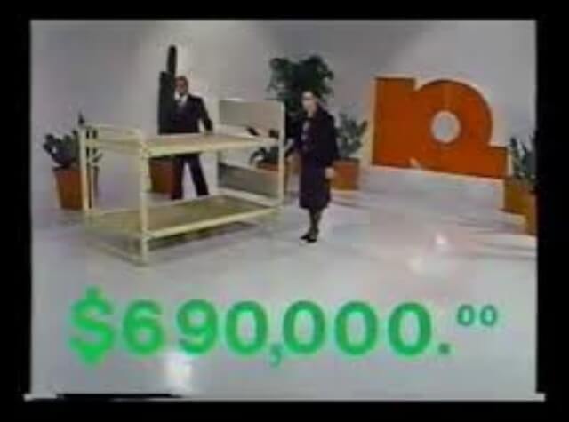 Screenshot of a television advertisement. A man and a woman stand in a room, near a bunkbed. 