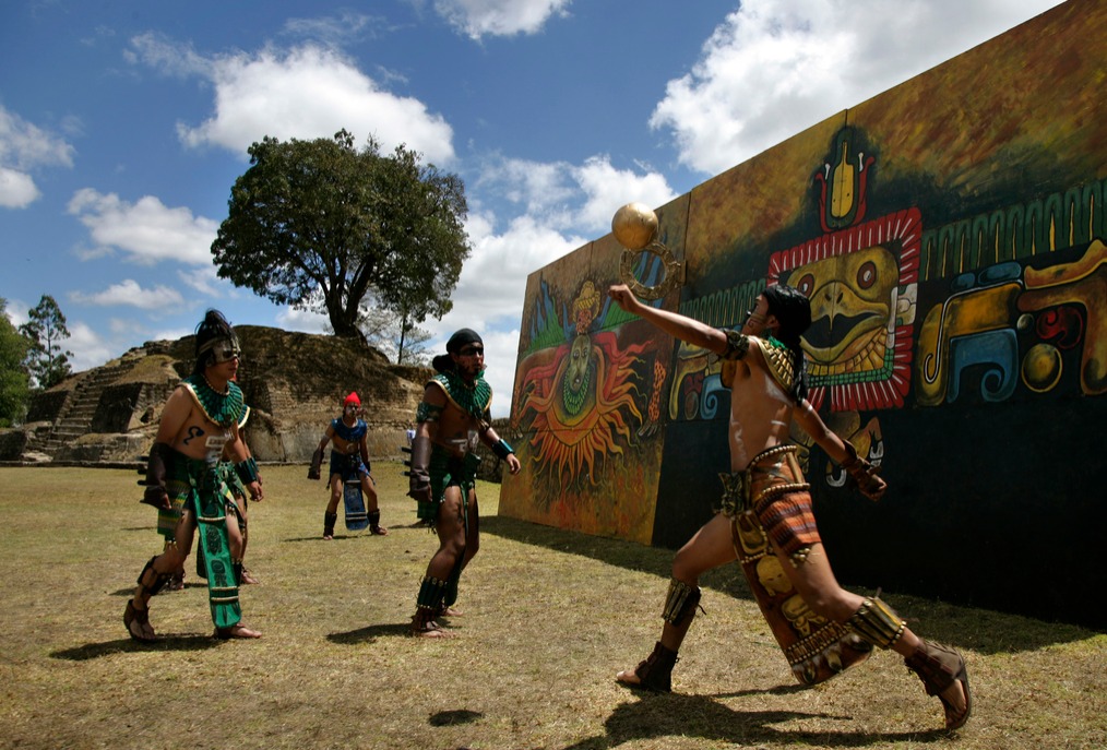 Men play an ancient Mayan ritual game called Juego de Pelota Maya, a Mayan ballgame, at the Iximche ruins. 