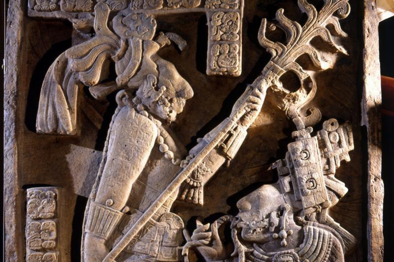 Carving of Lord Shield Jaguar and his wife Lady Xoc is performing a blood sacrifice by drawing a thorn rope through her tongue.