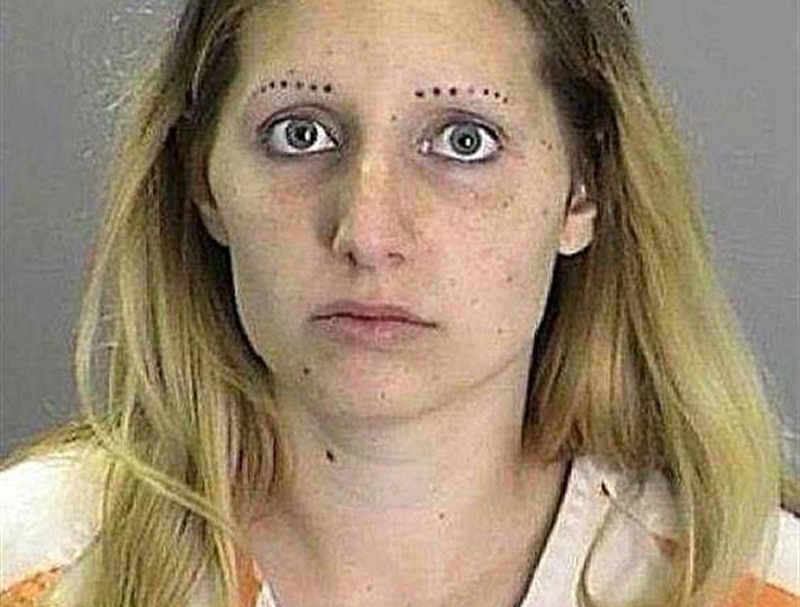 a mugshot of a woman with dotted eyebrows