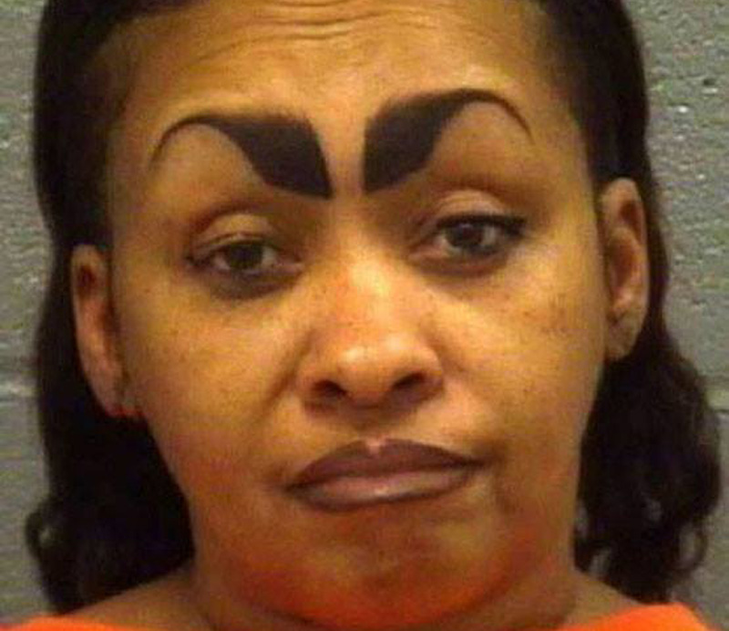 a mugshot of a woman with eyebrows