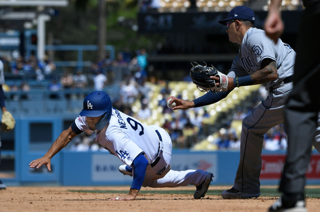 #9 of the Los Angeles Dodgers avoids a tag at third base by Manny Machado #13-1159712933