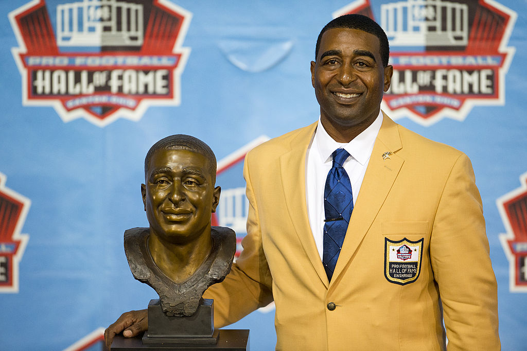 cris carter-175472795 CANTON, OH - AUGUST 3: Former receiver Cris Carter of the Minnesota Vikings poses with his bust during the NFL Class of 2013 Enshrinement Ceremony at Fawcett Stadium on Aug. 3, 2013 in Canton, Ohio.