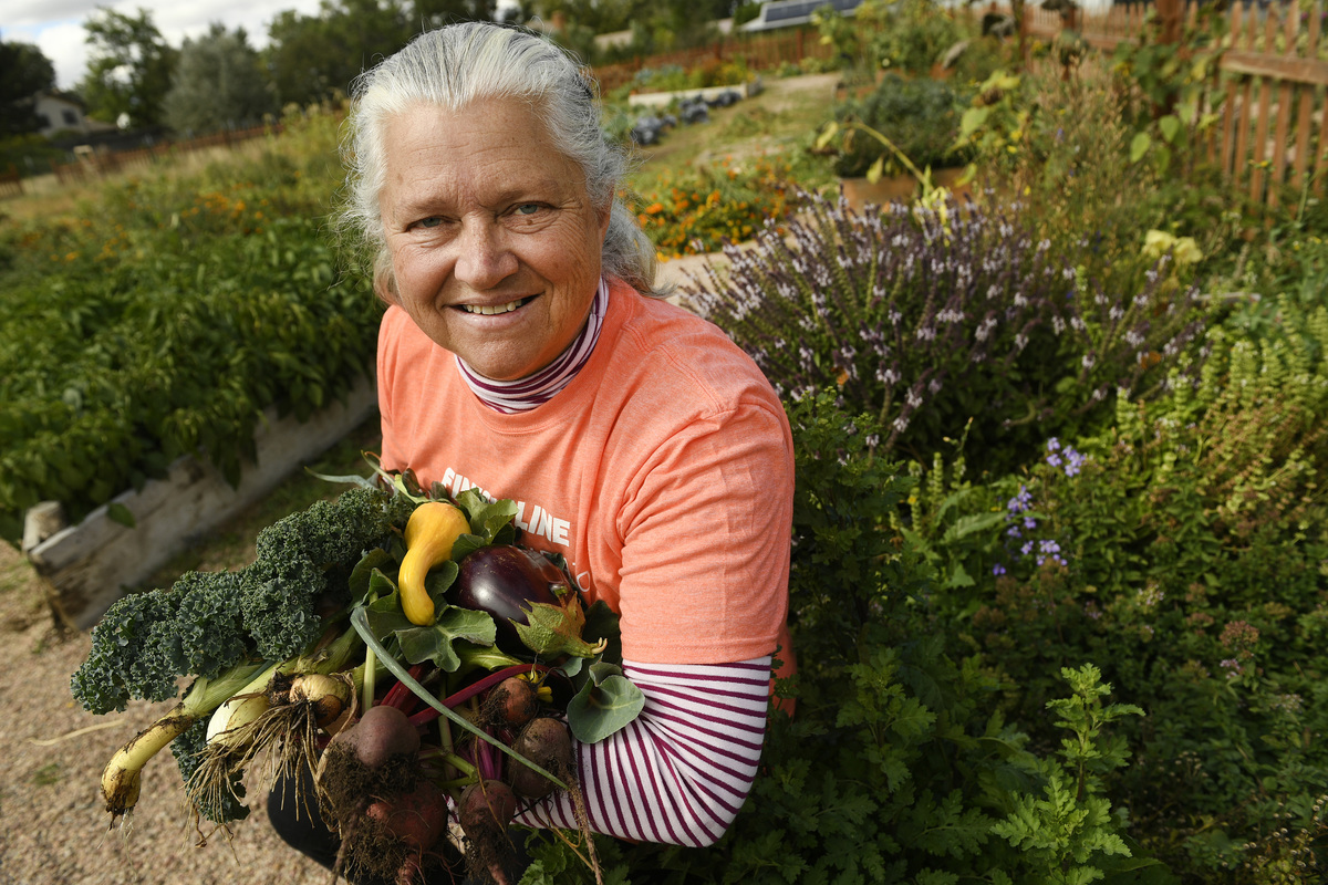 woman proud of veggies she grew