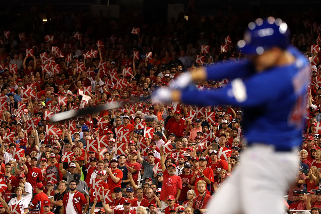 Fans react with 'K' strikeout signs as Anthony Rizzo #44 of the Chicago Cubs swings during the fourth inning
