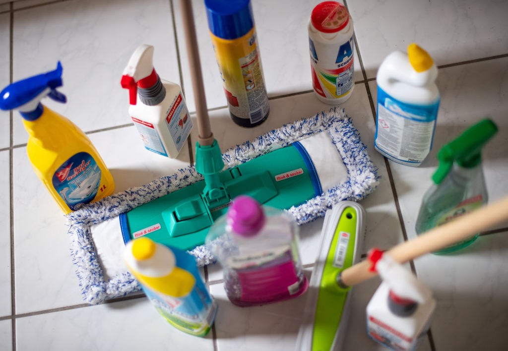 cleaning products arranged on a tile floor
