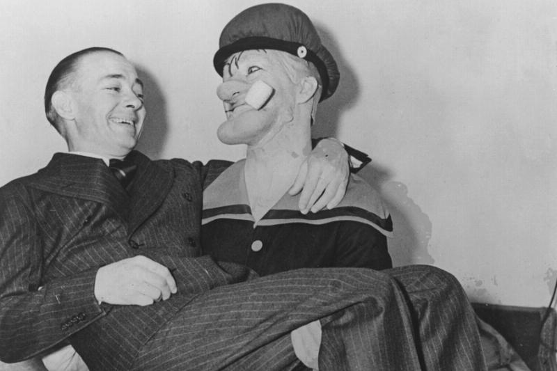 Man dressed as Popeye, holding another man