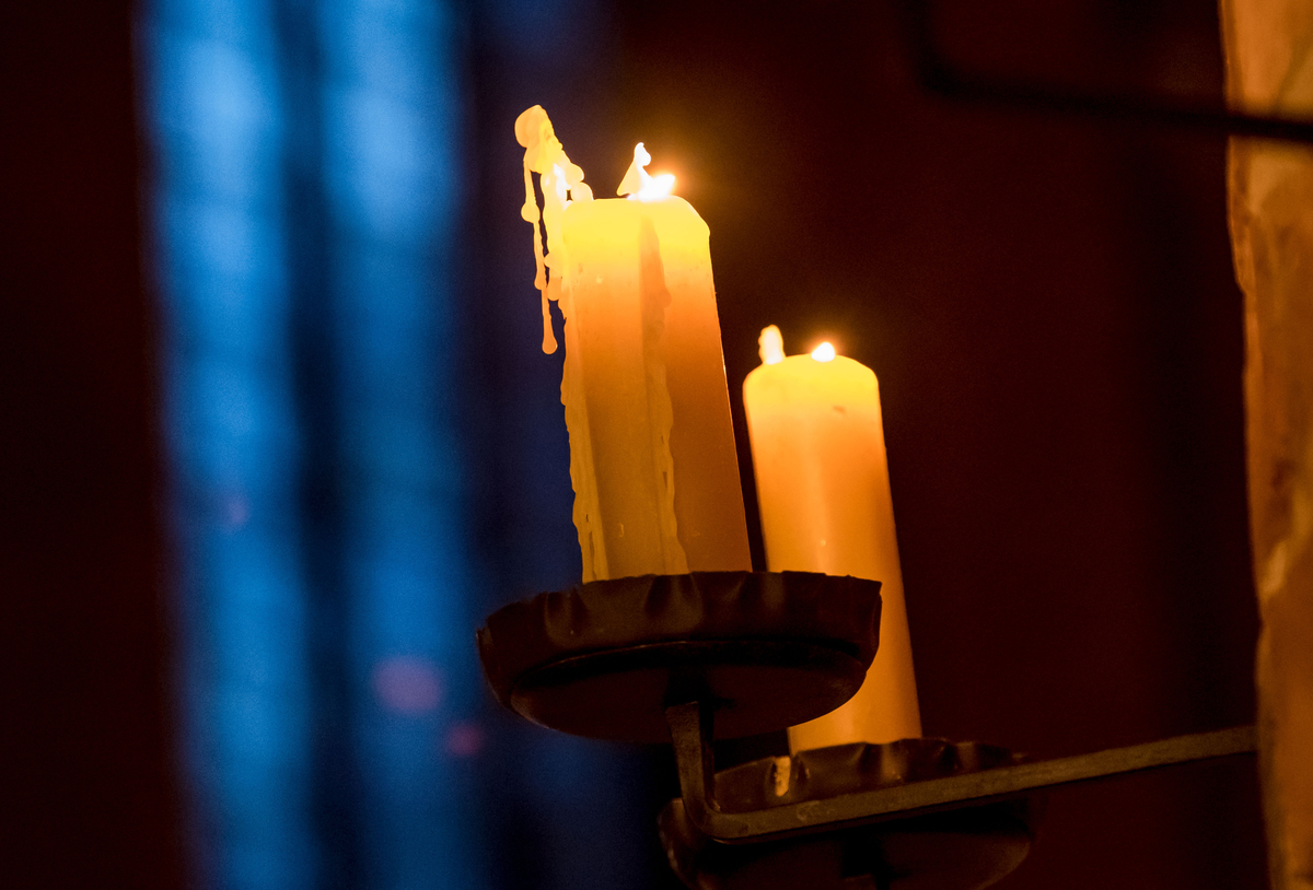 Candles burn at a Church during Christmas Eve service in Germany