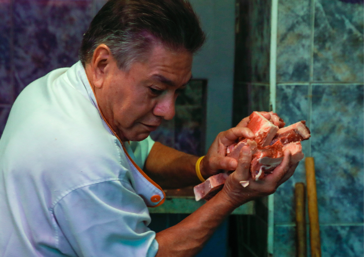 A man selling meat at the Guaicaipuro market. 