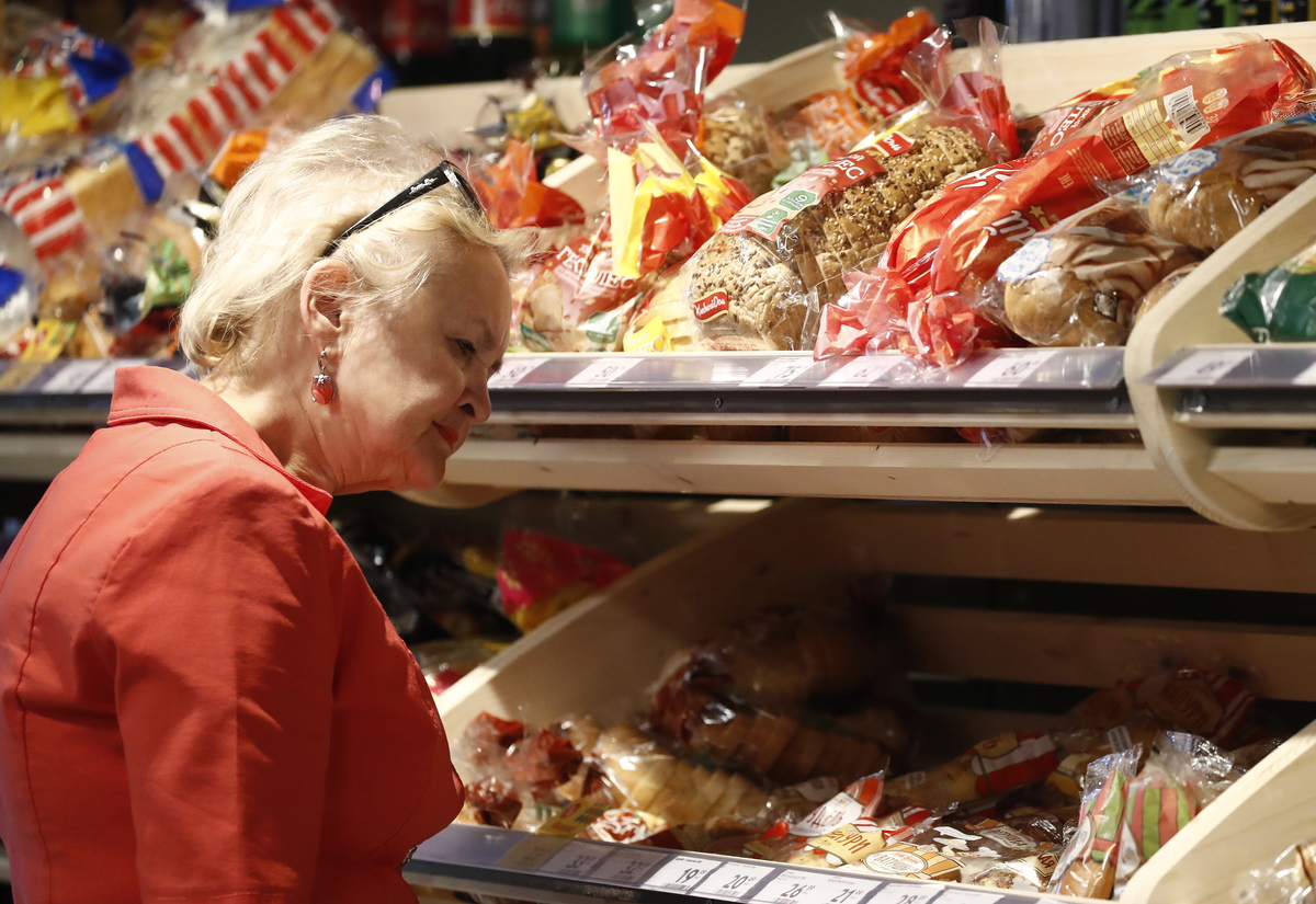 A customer choosing bread at a Pyaterochka supermarket