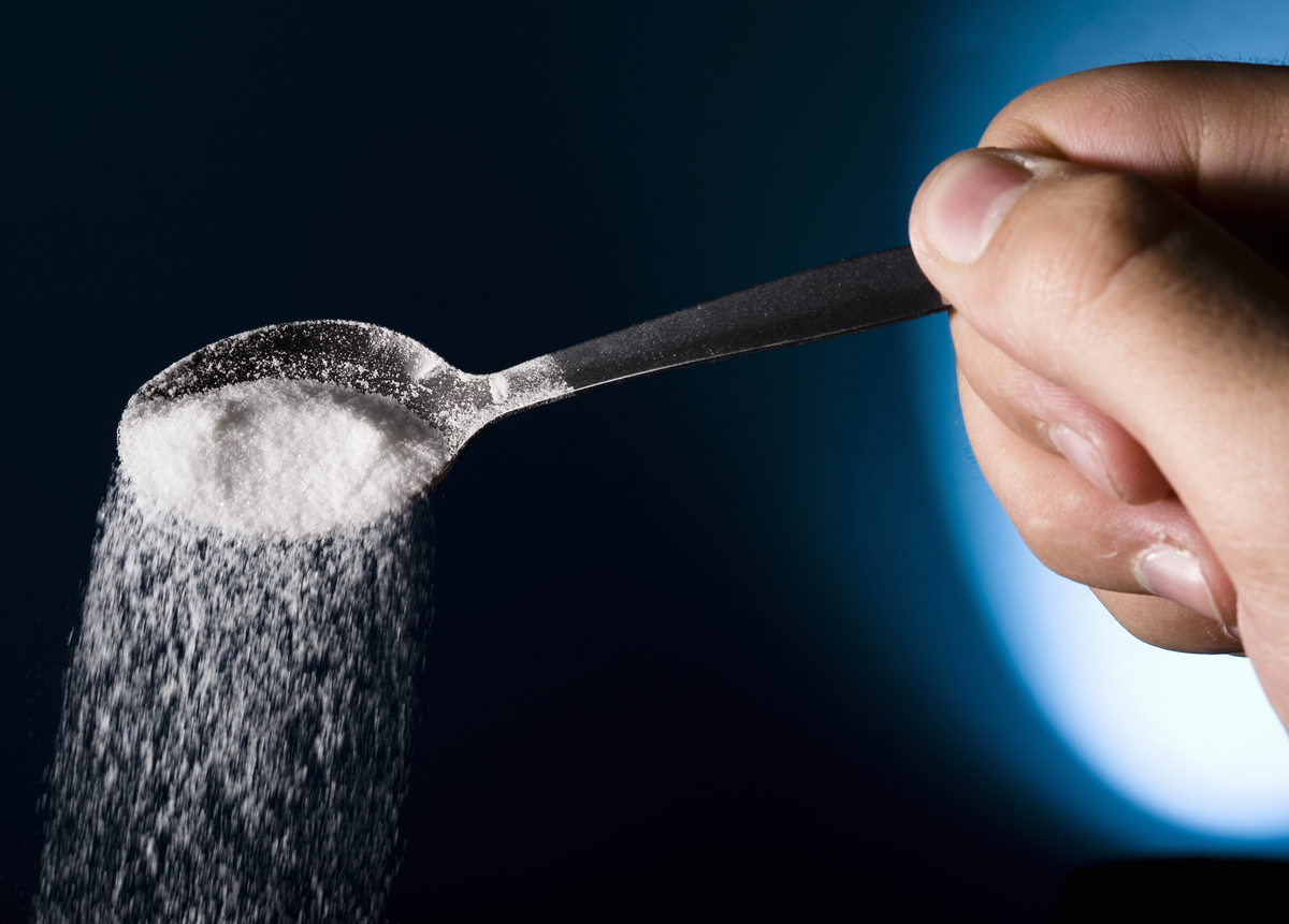 Salt spilling out from spoon 