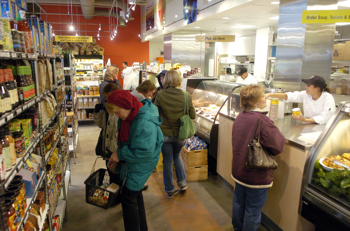 Shoppers pack the aisles and deli counter at Cook's Fresh Market