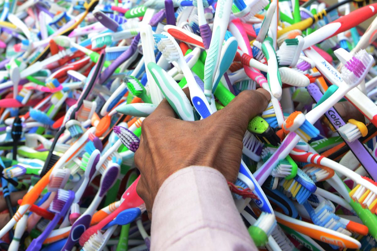 An Indian customer looks at cheap toothbrushes sells for five Indian rupees on a cart at the roadside in Amritsar