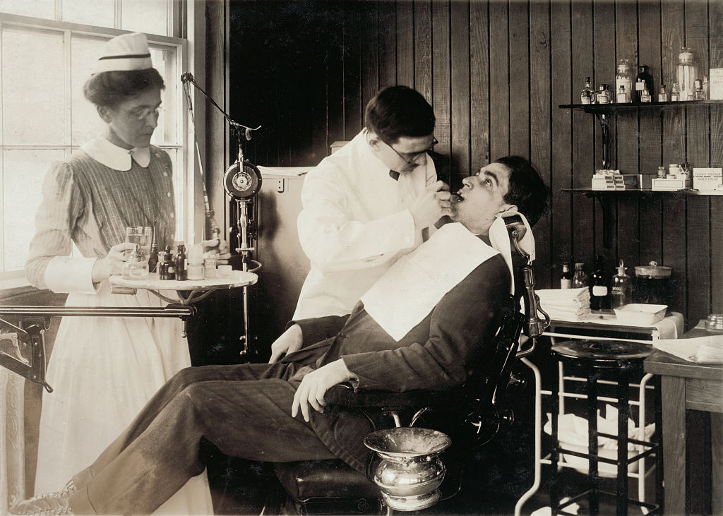 Photograph of a patient in a dentist's chair having dental work 