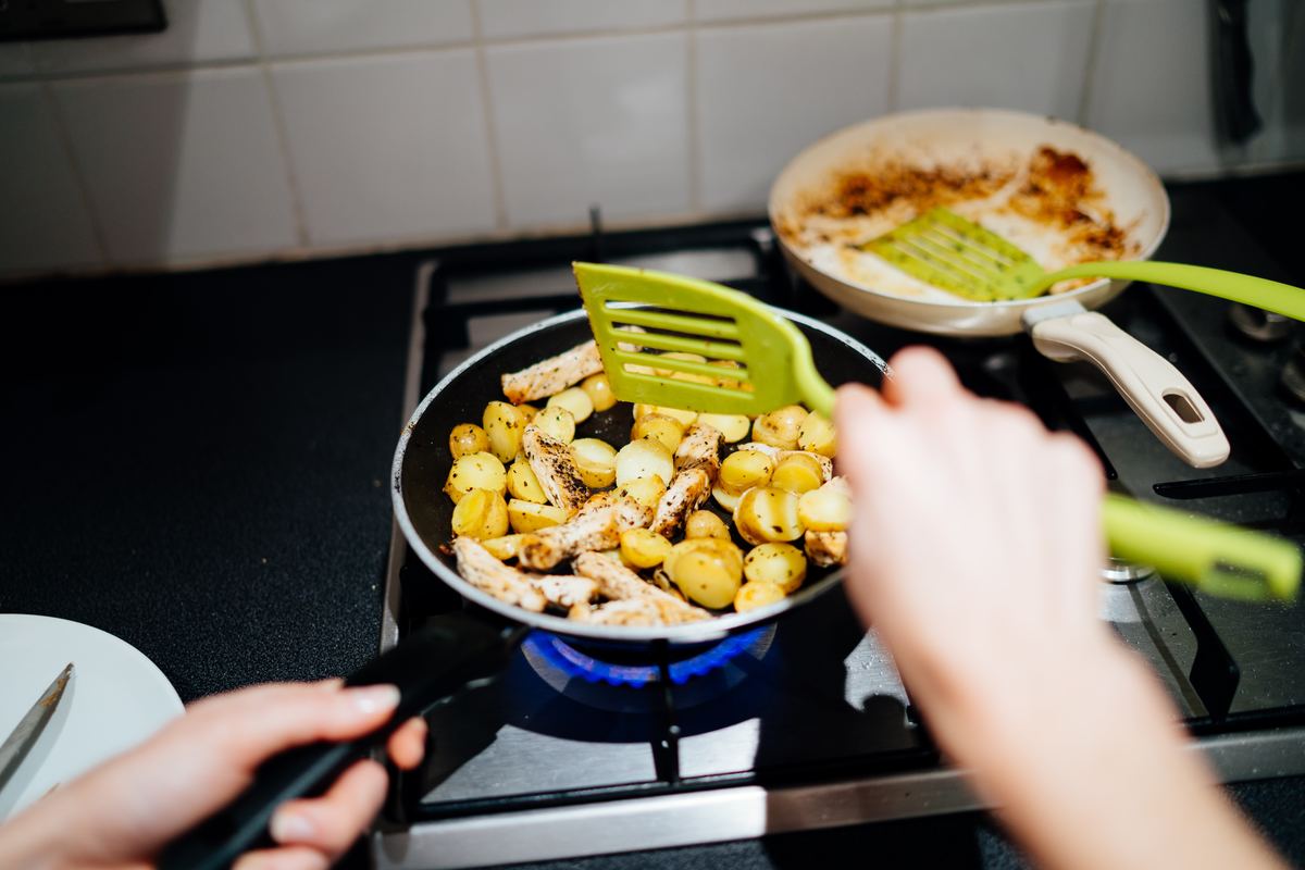 Frying potatoes in a pan over the stove