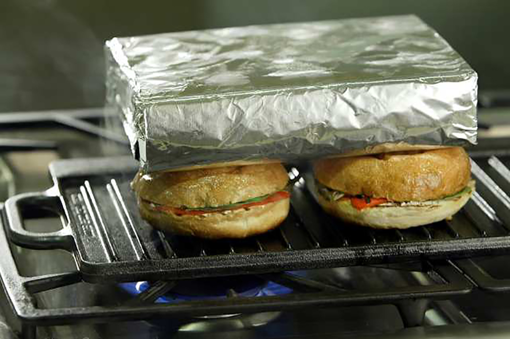 Brick wrapped in foil on top of sandwiches 