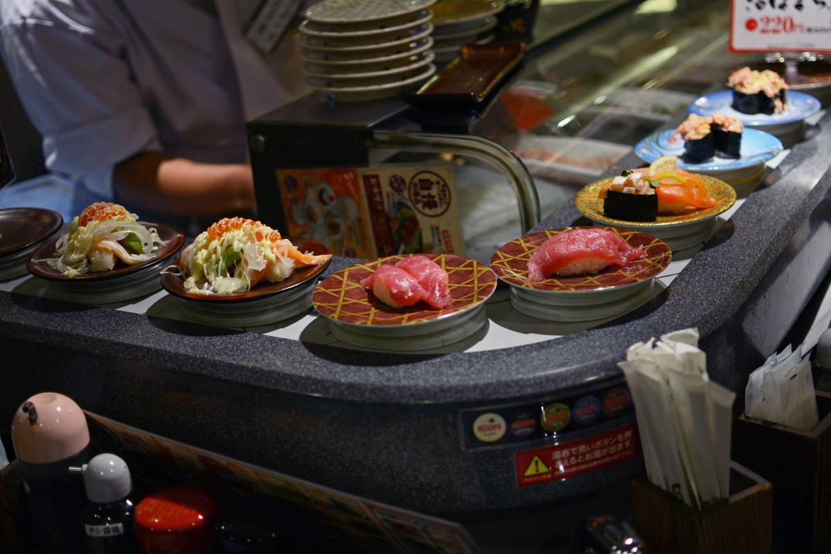 Sushi sits on a rotating bar in a restaurant in Tokyo.