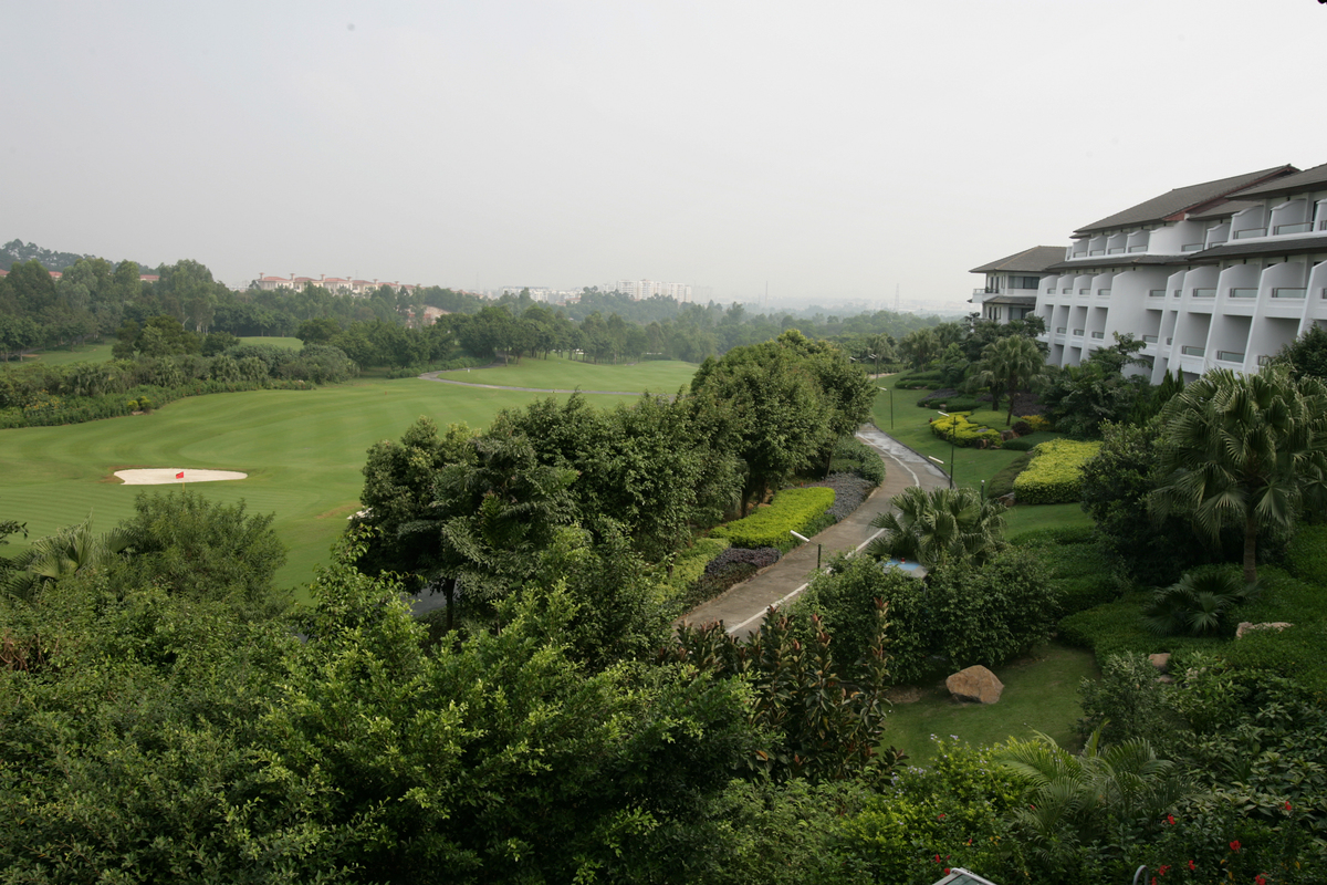 A lake borders a club house at Mission Hills Golf Club, China.