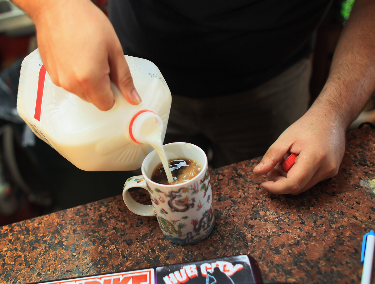 Kyle Kaly adds milk to his cup of coffee at the Undergrounds Coffeehaus.