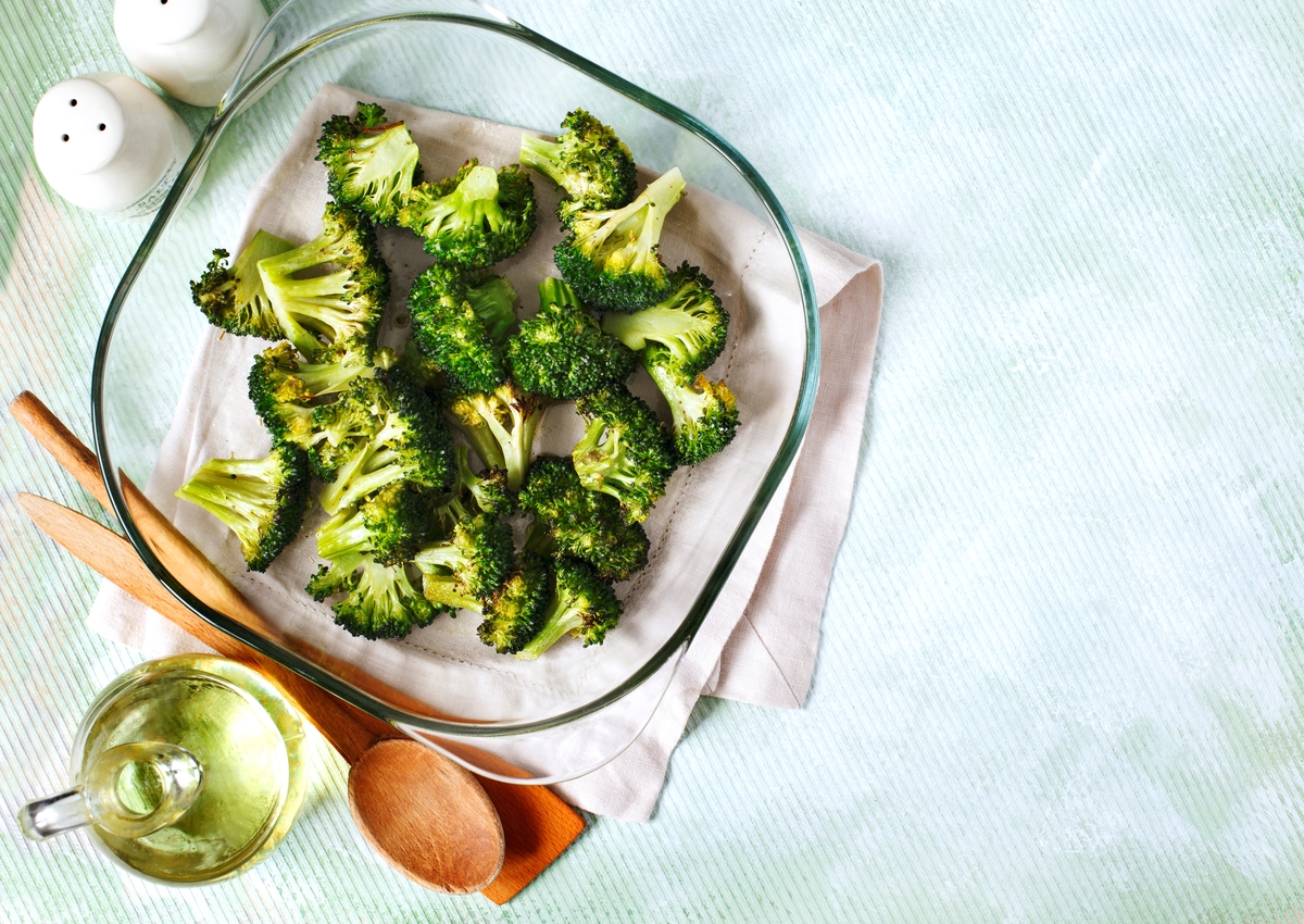 Baked broccoli sits in an oven-safe glass bowl.