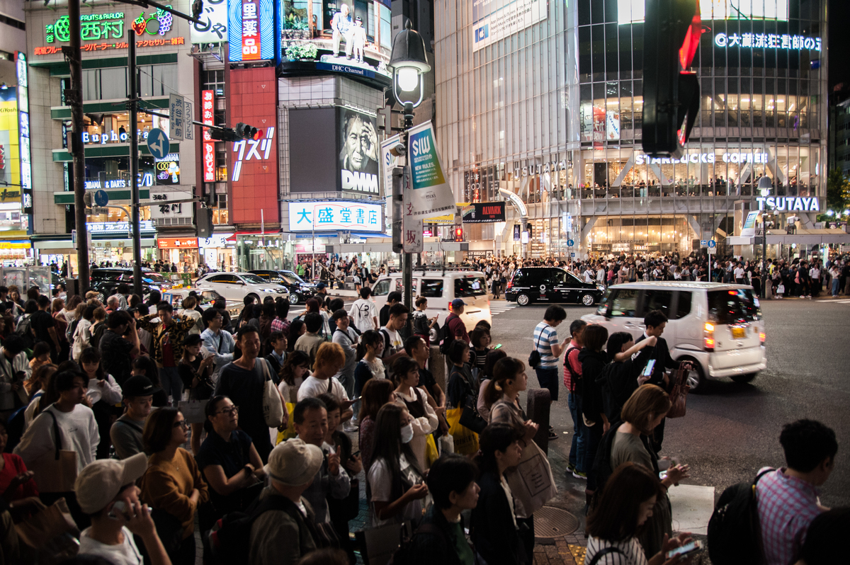 Crowds wait at Shibuya Crossing, Tokyo, the busiest pedestrian crossing in the world.