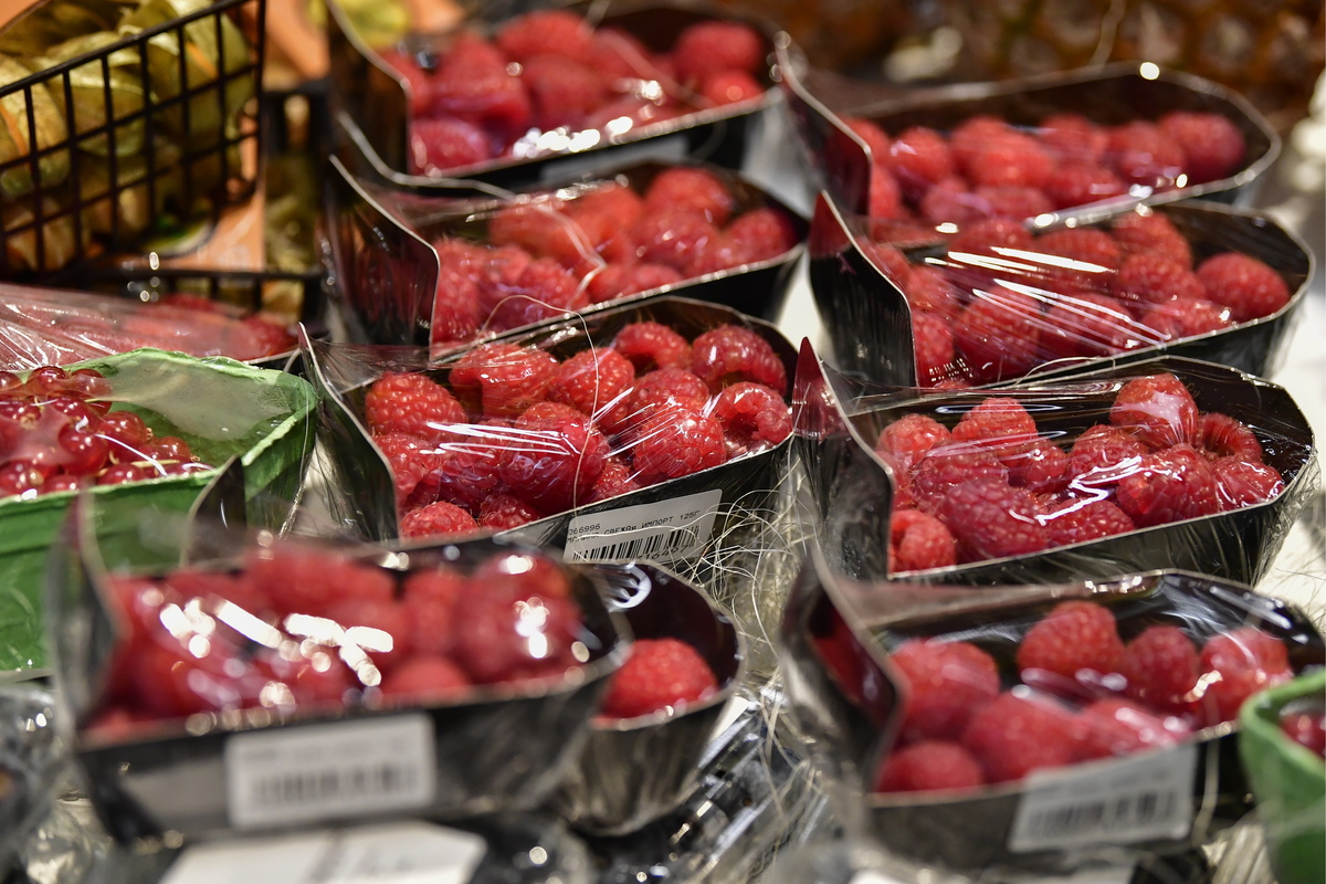 Raspberries wrapped in plastic are on display in a new hypermarket.