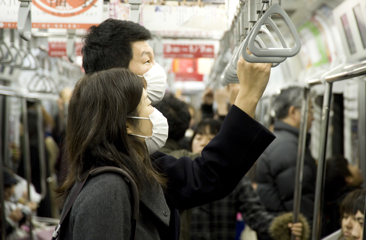 Passengers wearing face masks ride the train in Tokyo, Japan. 