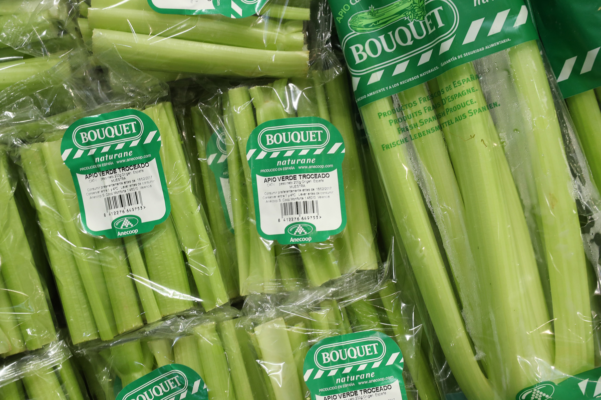 Bagged organic celery lies on display.