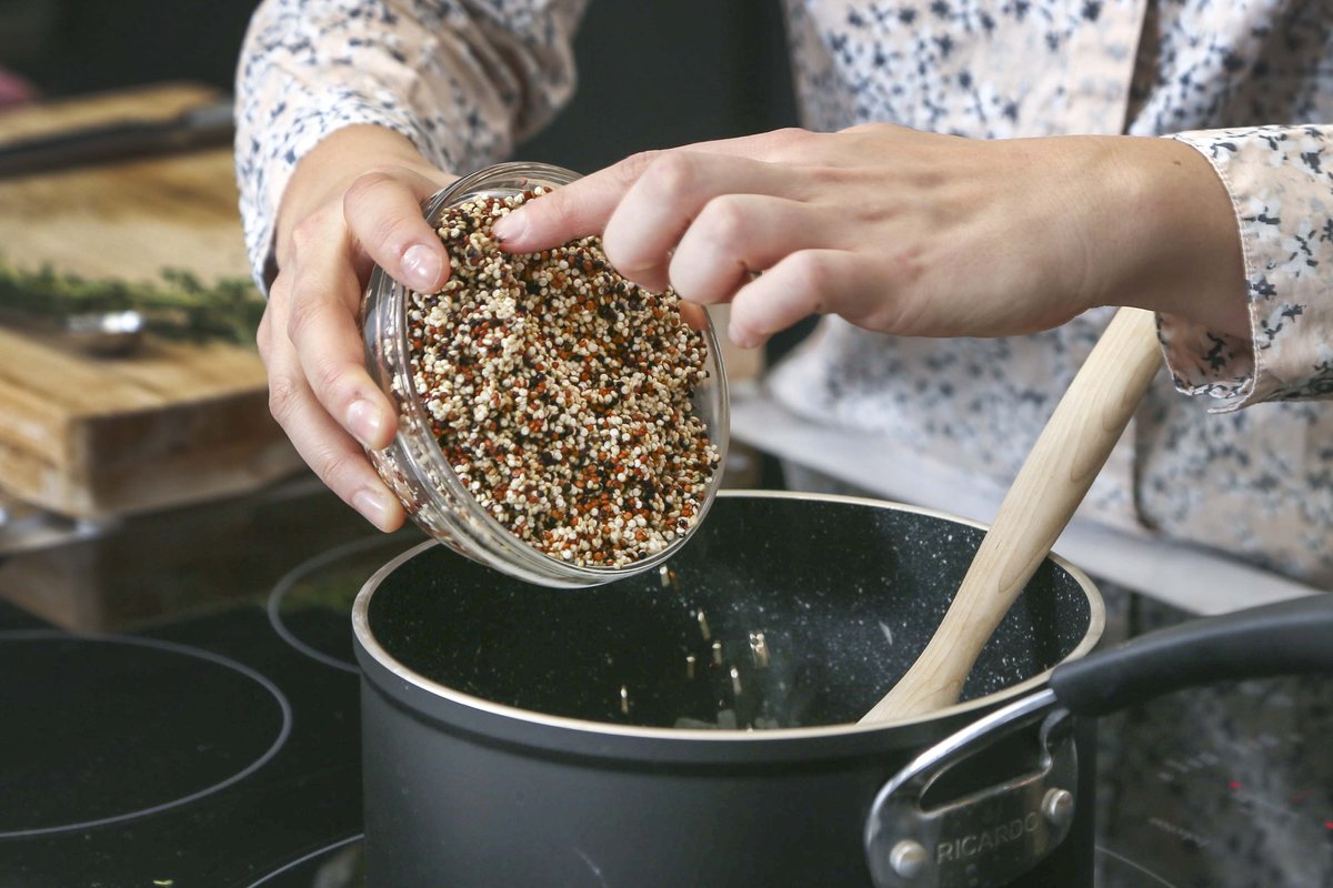 Cookbook author Laura Wright pours dried quinoa into a pot.