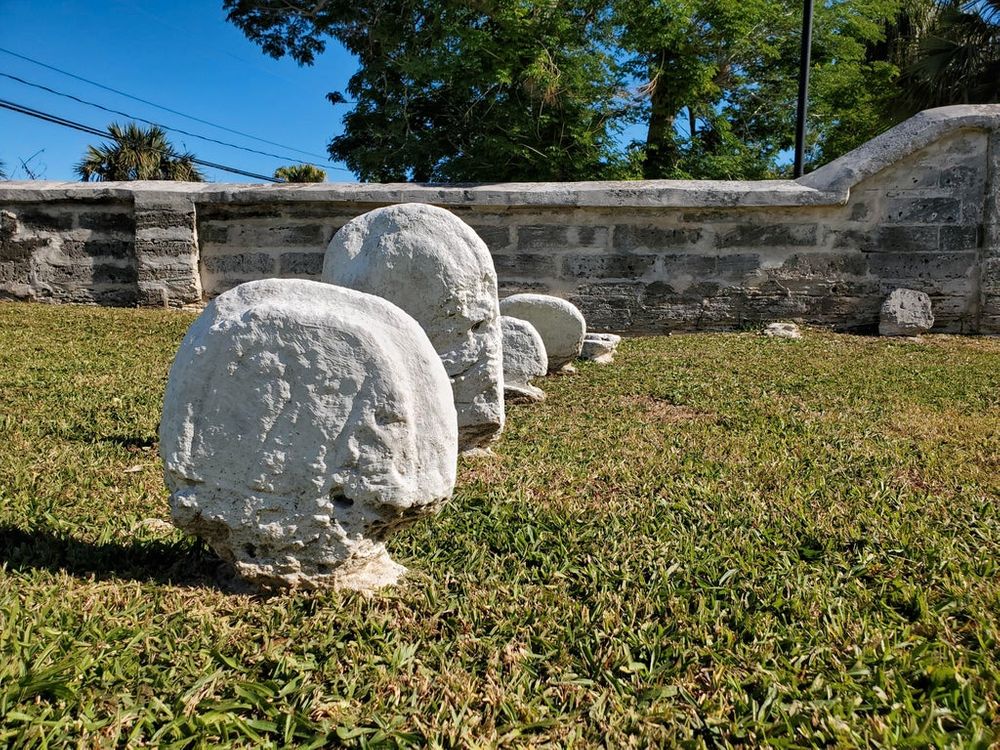 graveyard headstones that are worn away at the bottom
