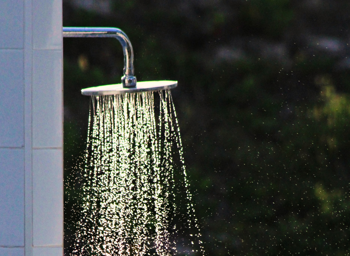 A shower head sprays water.