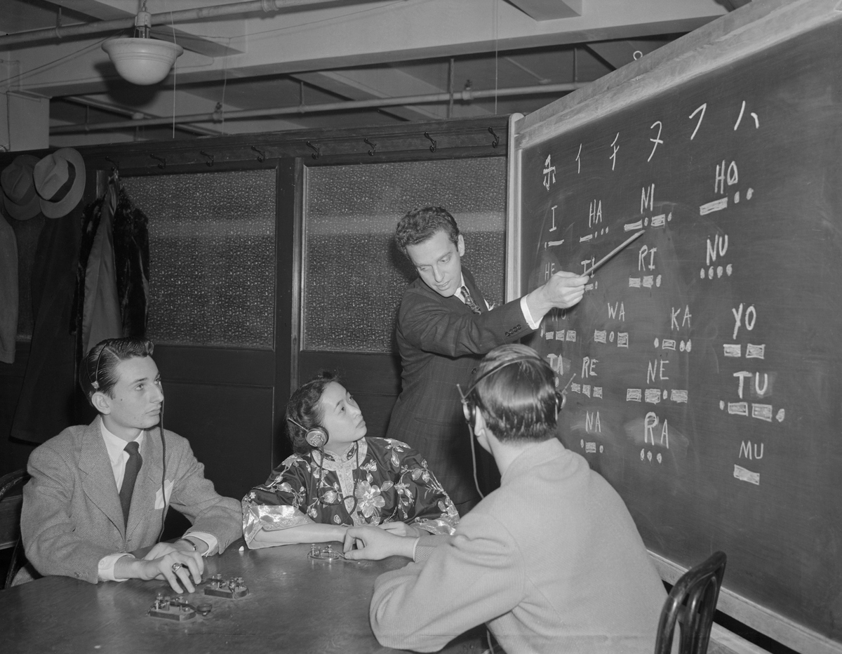 Frank Melville, Jr., points out Japanese characters to students at his Melville Aeronautical Radio School, the first school in the nation to offer a course in Jap code deciphering.