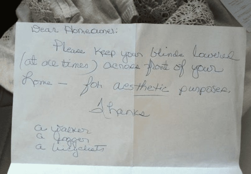 A note asks a neighbor to keep their blinds shut for aesthetic purposes.