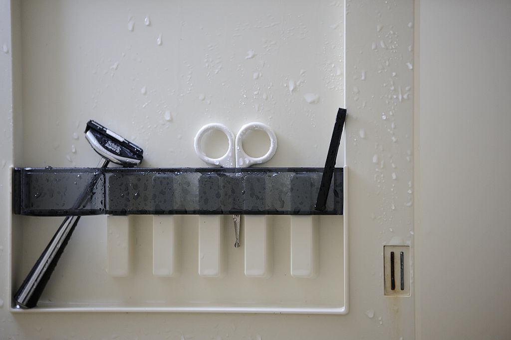 A straight razor and a small chisel are seen in the bathroom