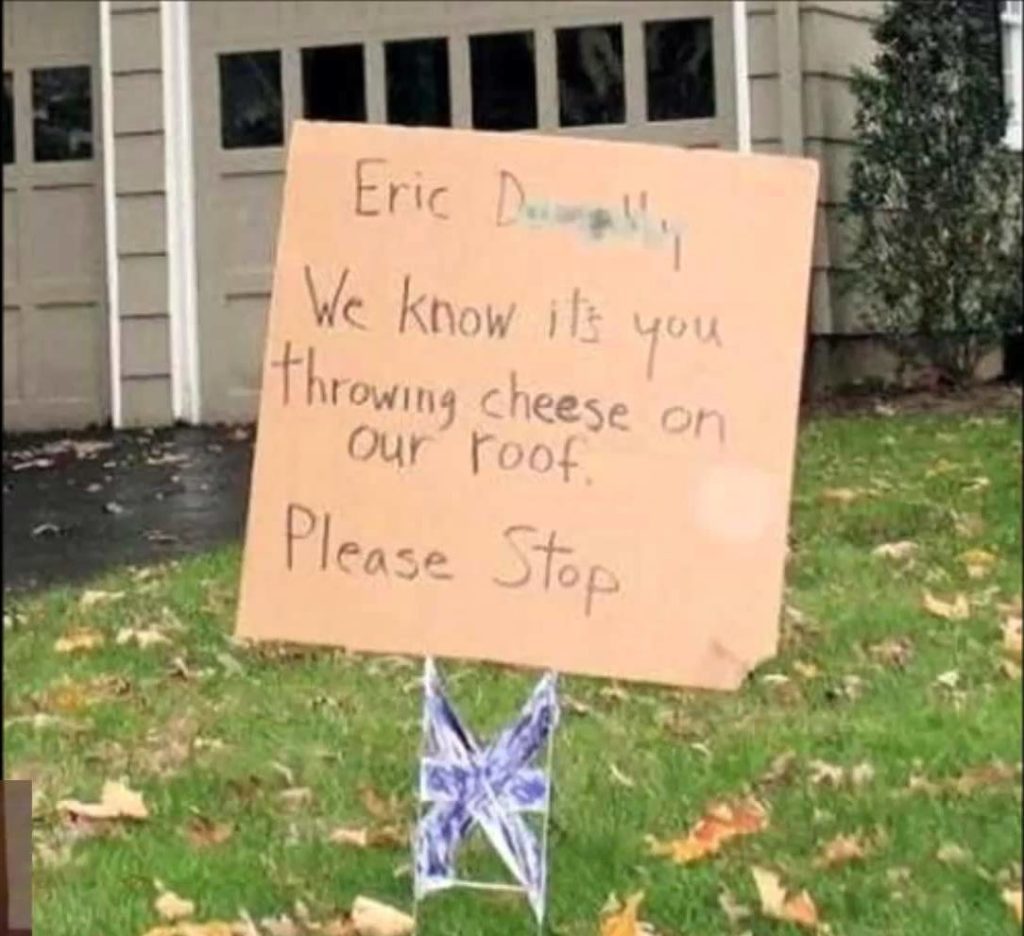A sign asks a neighbor to stop throwing cheese on the roof.