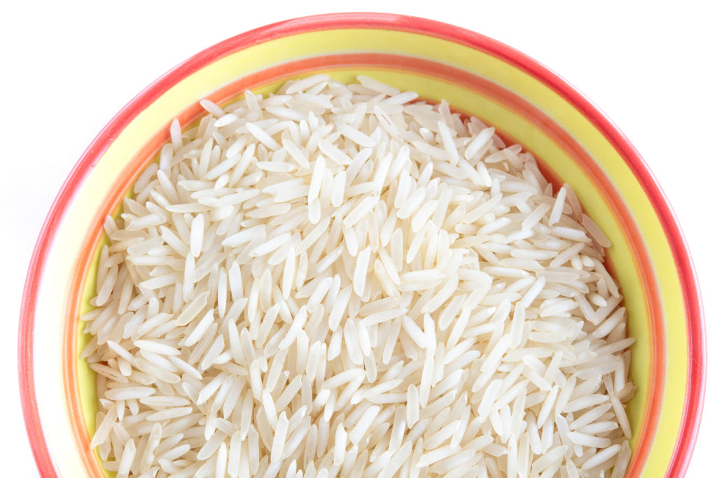 white rice in a yellow and pink ceramic bowl