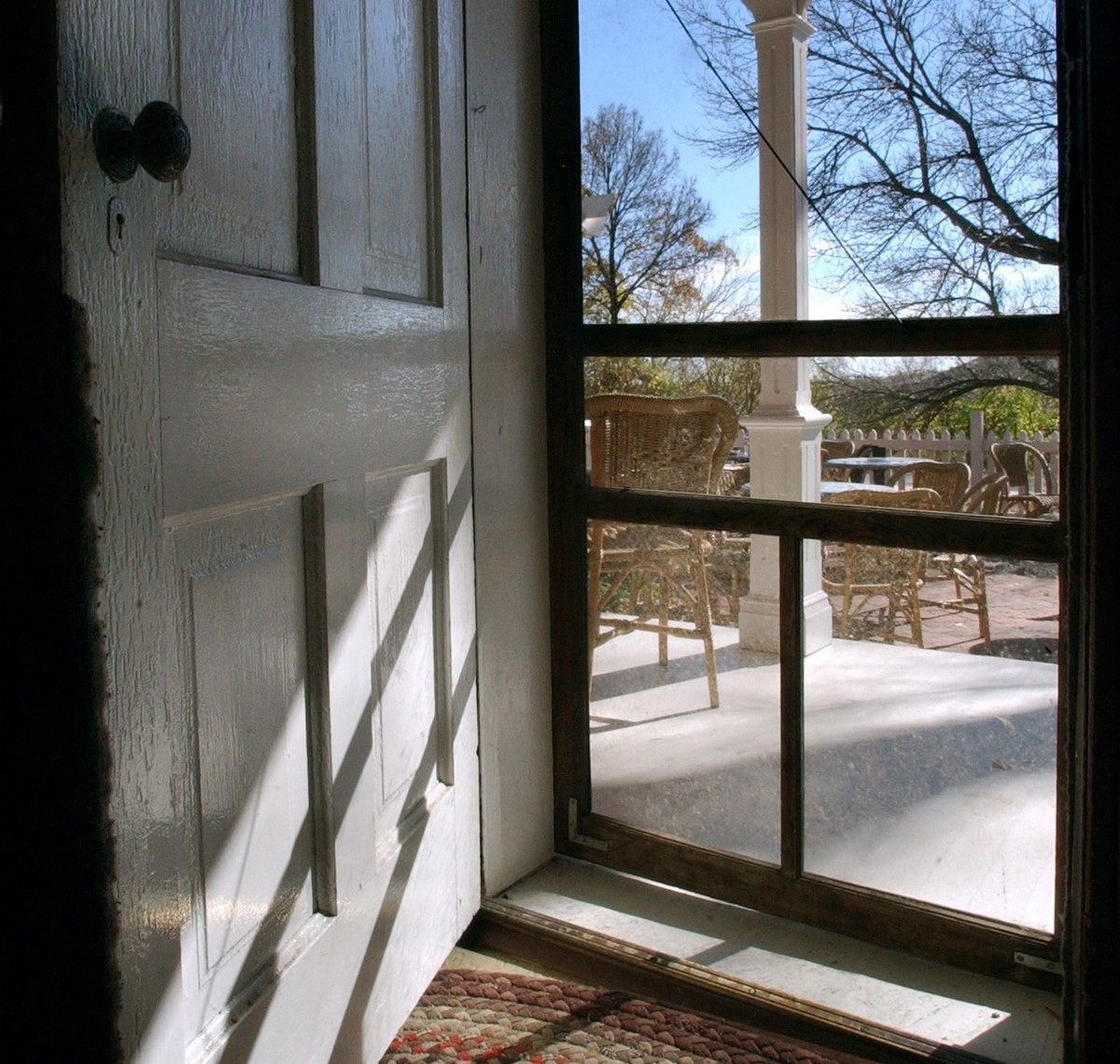 A front door is open to a screen door.