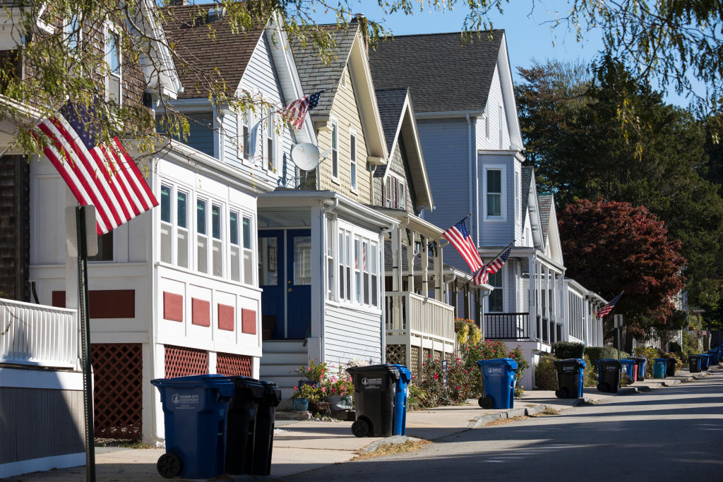 Trash bins line a street.