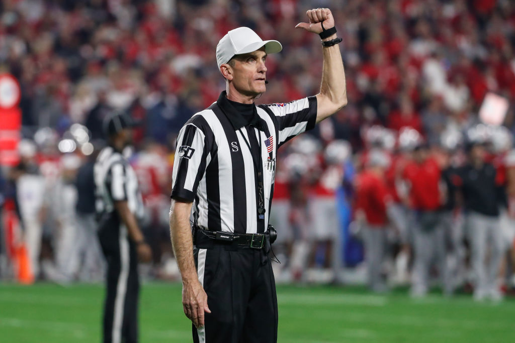 A referee does an ejection sign.