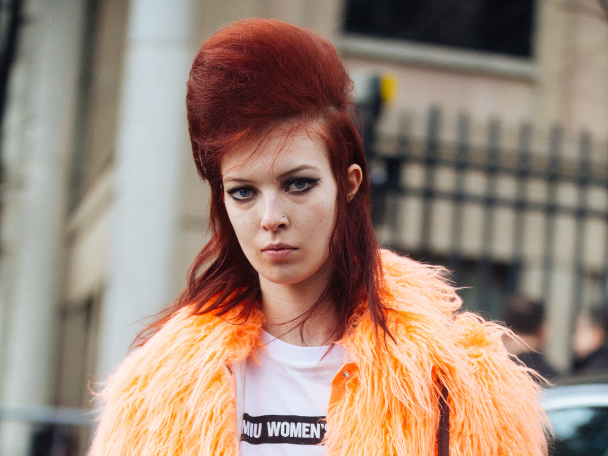 A model in Paris has red puffed and teased hair.