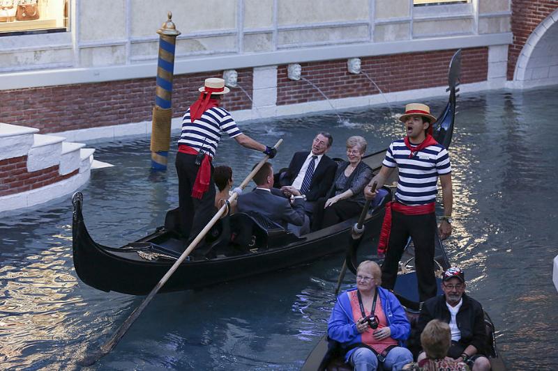 people riding in gondolas in las vegas