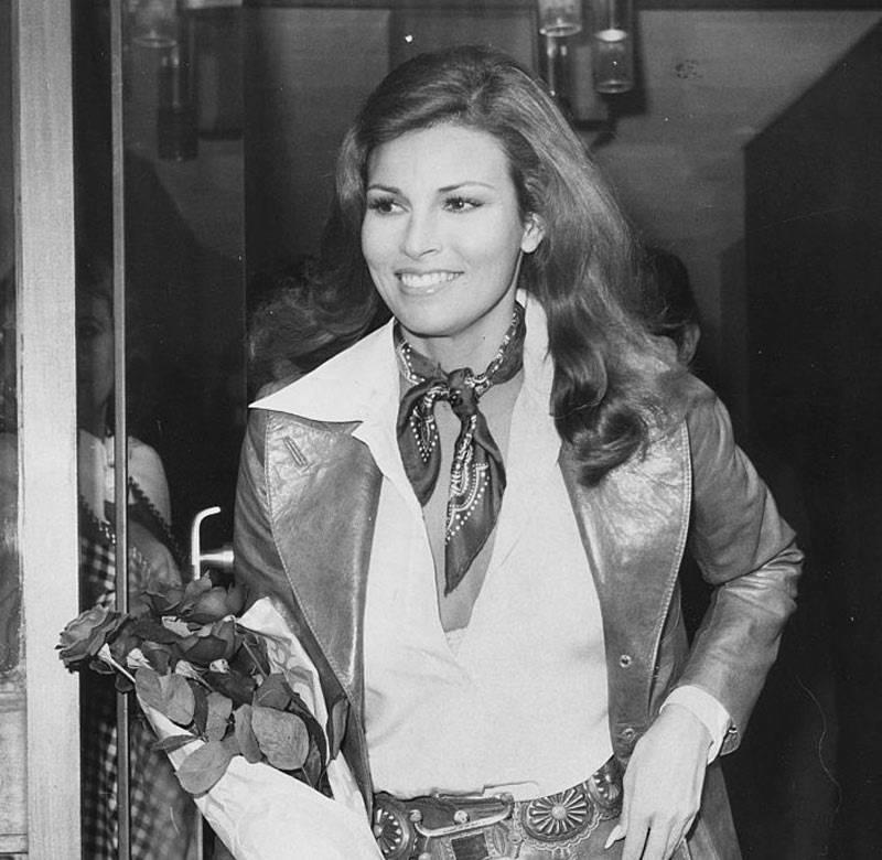 Actress Raquel Welch carrying a bouquet of roses as she leaves the studio after filming an interview for 'On the Ball', London, November 9th 1972.