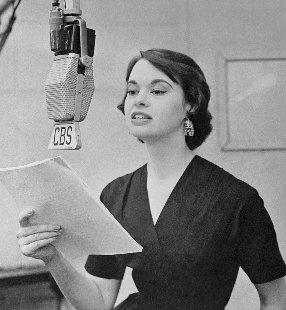 gloria vanderbilt reading a script on the radio
