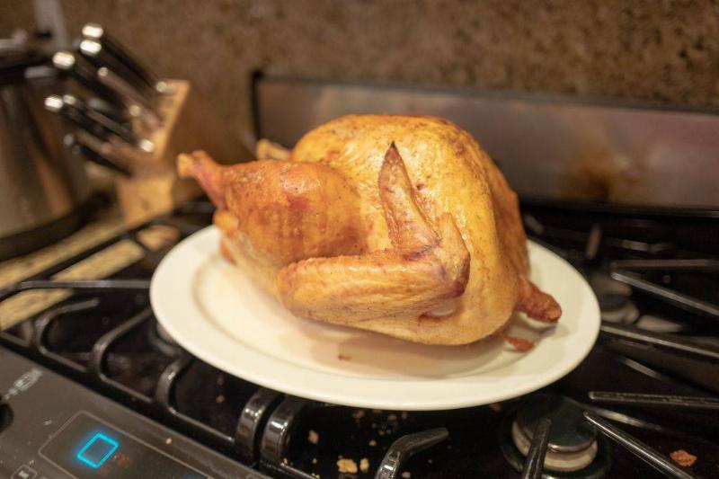 a whole turkey on a platter on top of a stove