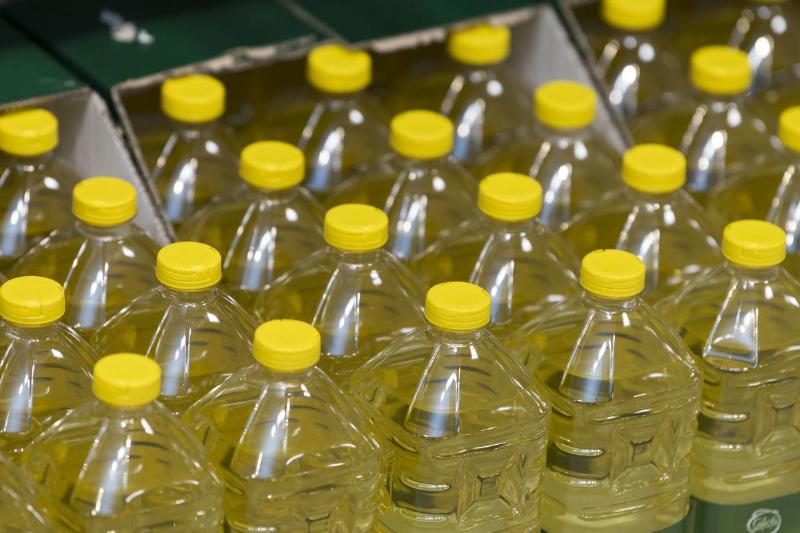 Bottles of vegetable oil are seen on sale.