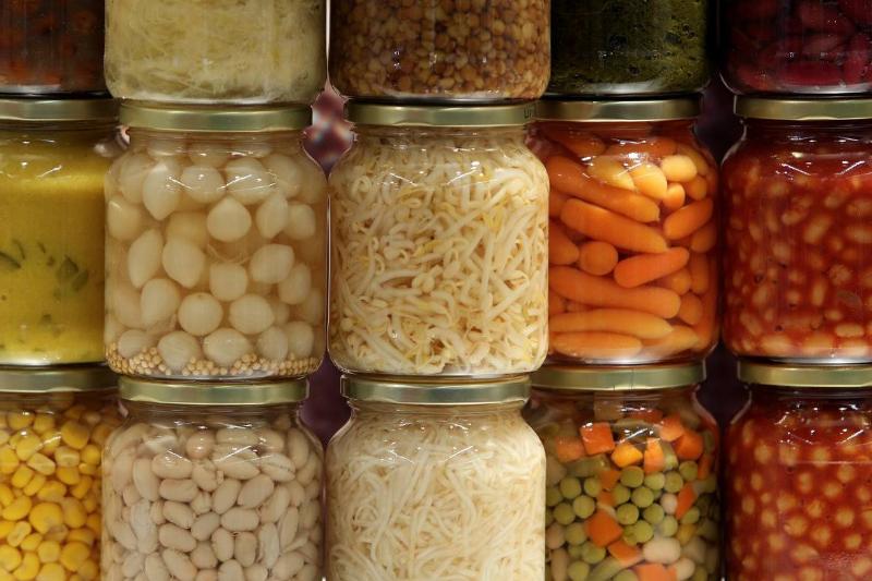 Canned vegetables are stacked and on display.