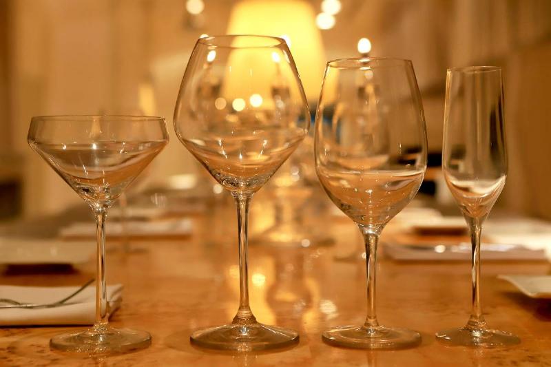 Empty wine glasses stand on a table.