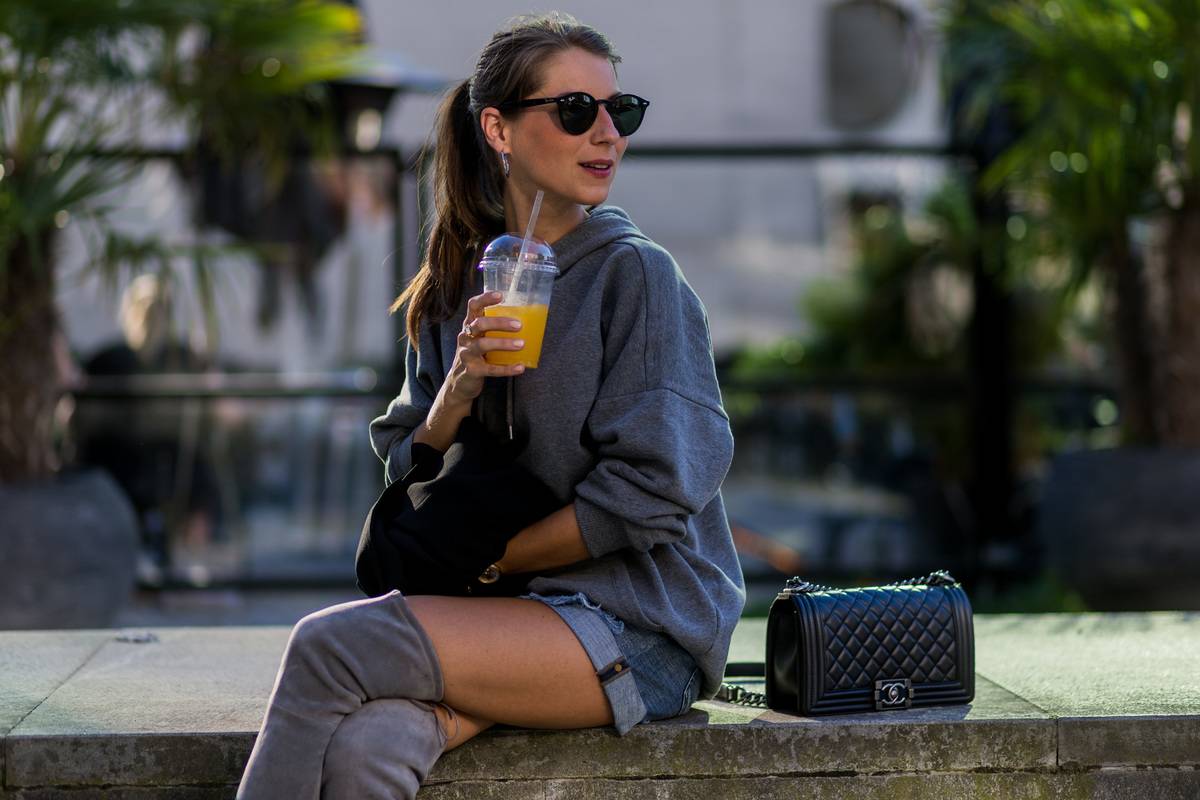 A woman drinks orange juice.
