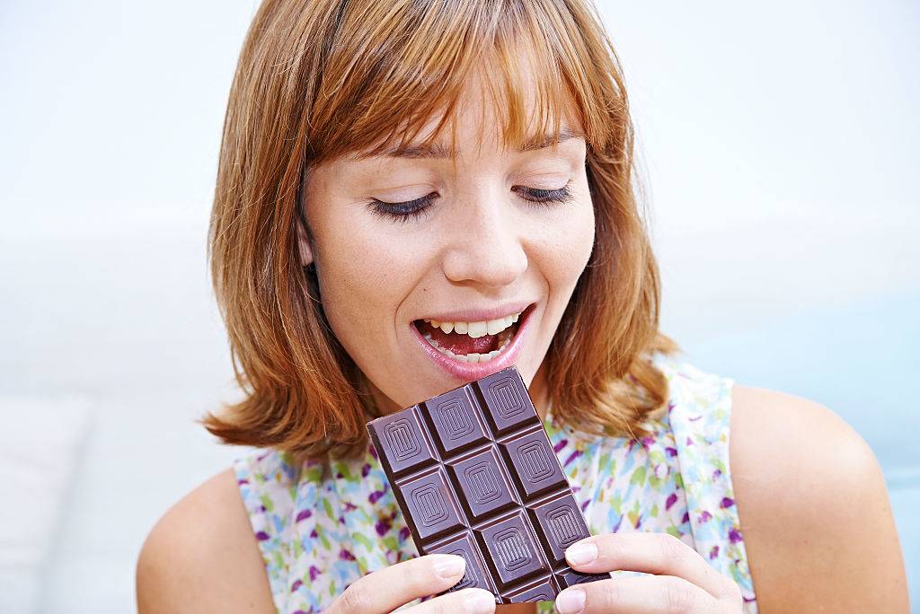 Woman eating chocolate bar