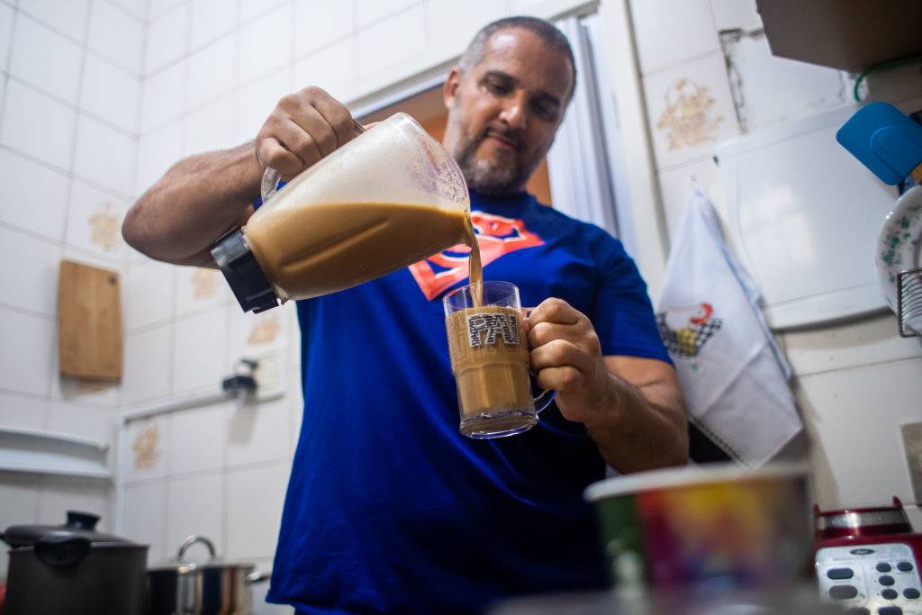 man pouring himself a smoothie